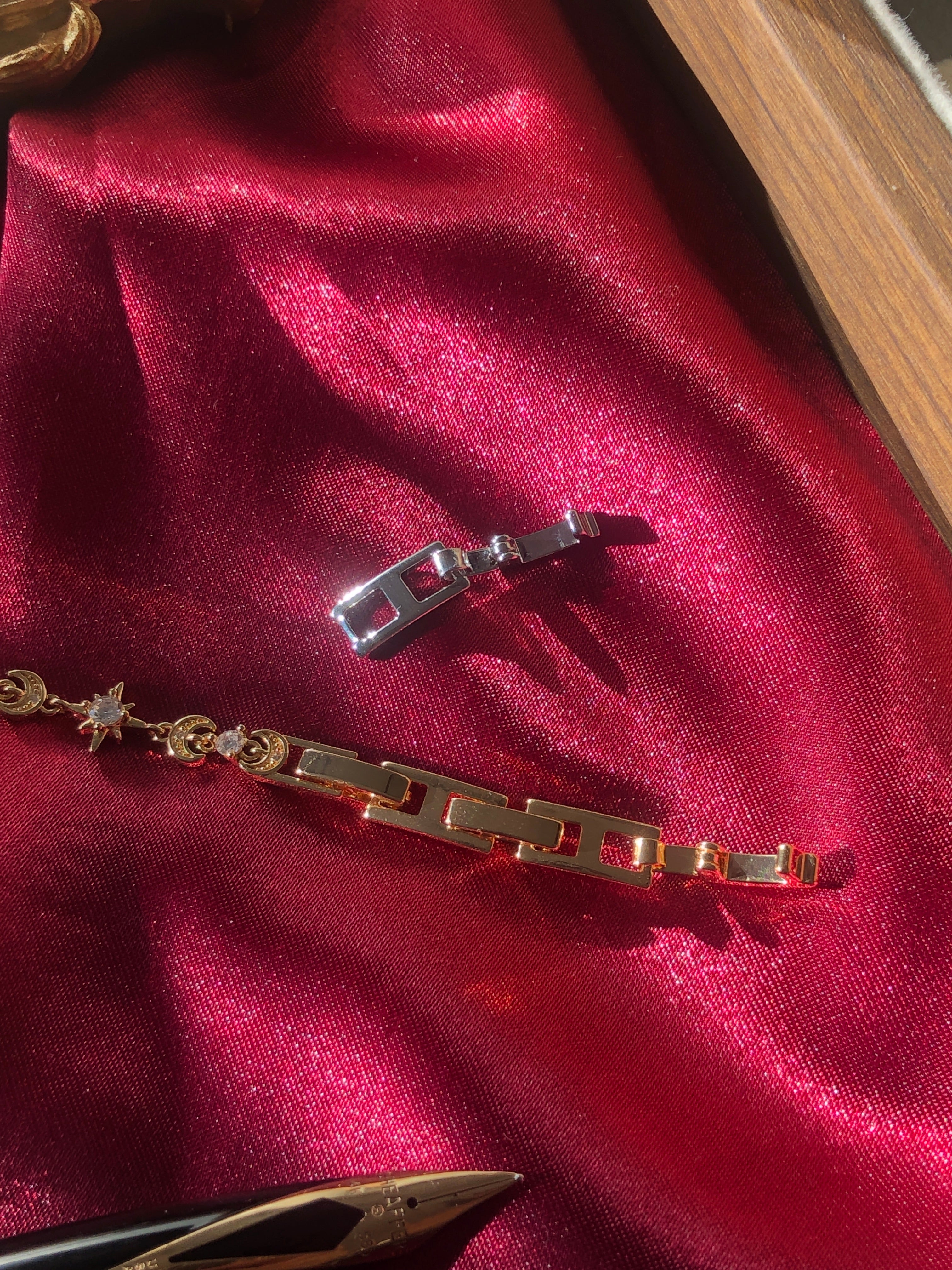 Gold bracelet with star and moon shaped charms