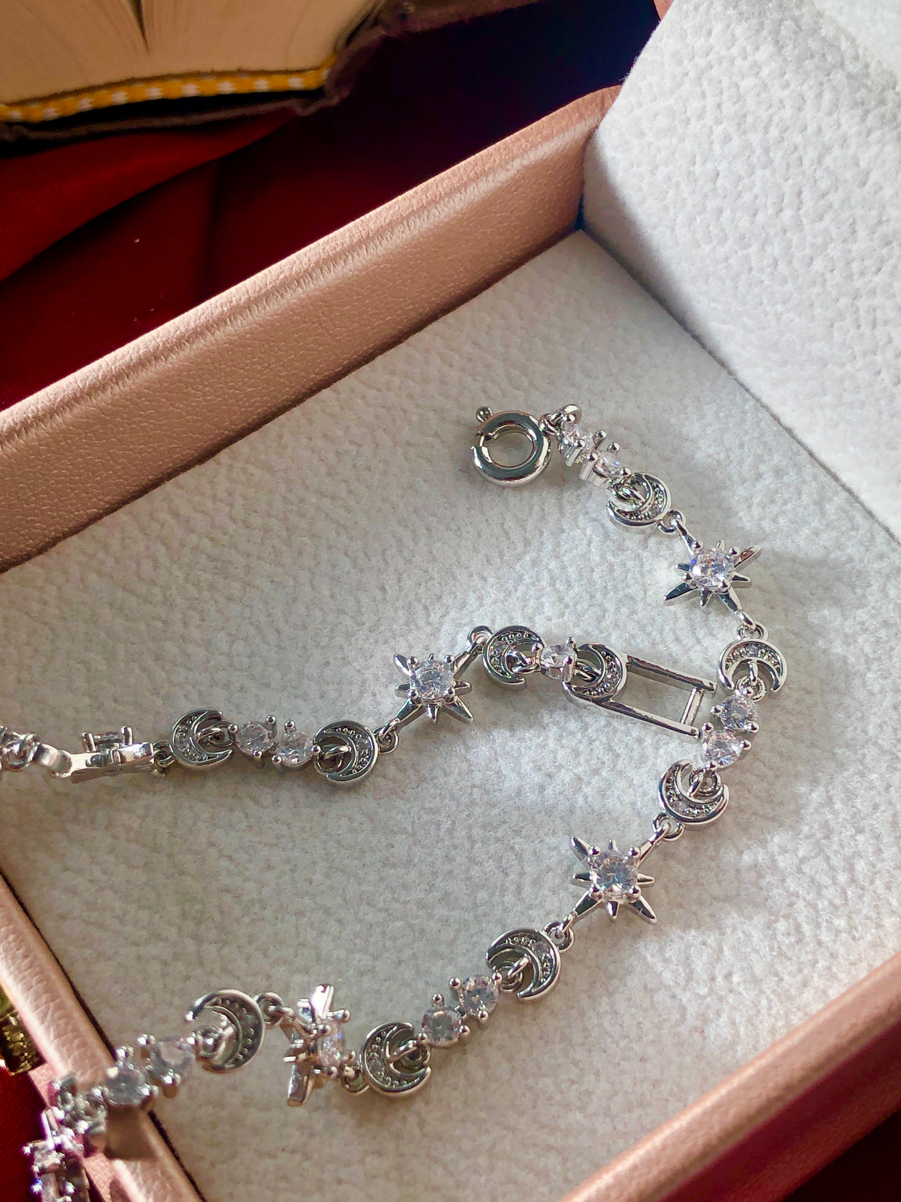 Silver bracelet with star-shaped beads on a soft surface