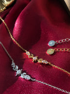 Sterling Silver and 18K Gold Star necklaces on a red fabric background